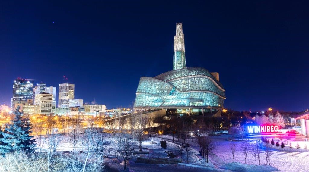 The museum against the Winnipeg city skyline in winter
