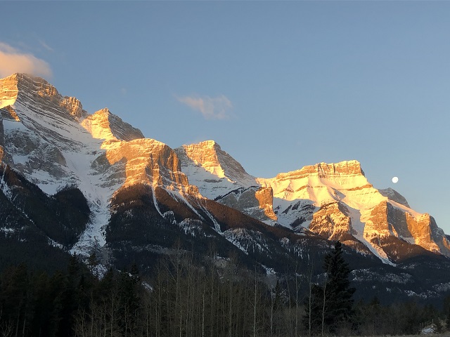 Moon over snow capped Mount Rundle