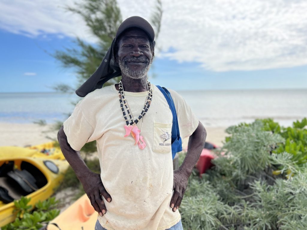 blue_hole-craftsman_leroy_glinton_helps_kayak_and_makes_conch_necklaces_credit_jennifer_bain